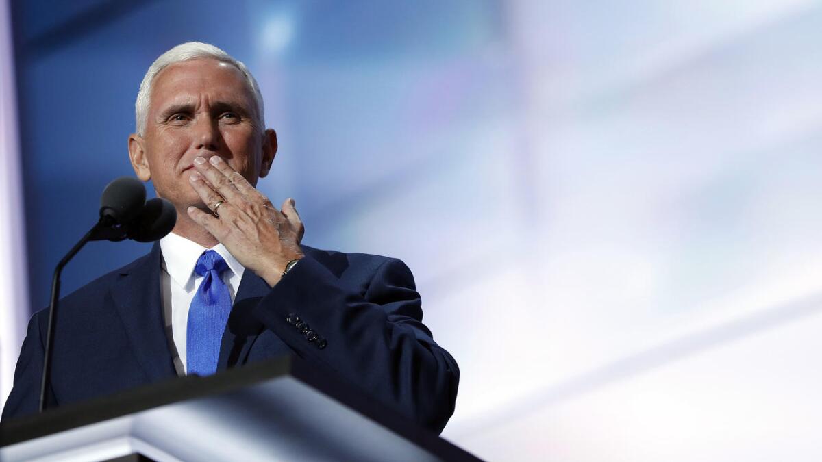 Republican vice presidential candidate Mike Pence blows a kiss to his wife as he speaks during the third day of the Republican convention.