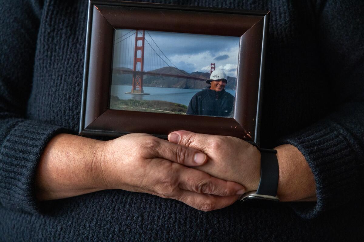 Sandra Muoz holds a photo of her husband, Luis Acensio Cordero.