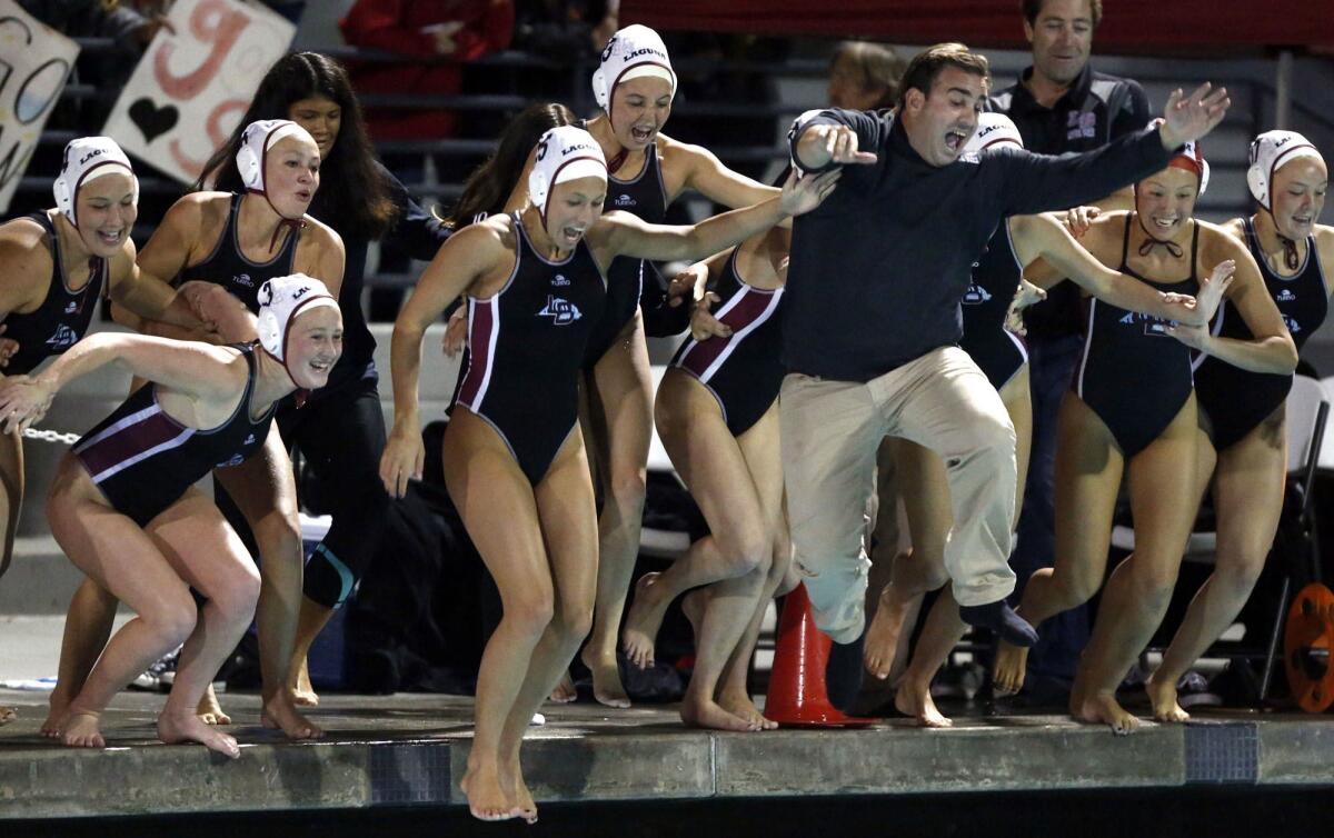 Laguna Beach coach Ethan Damato celebrates with his players after winning the 2015 Division 1 girls' water polo title.