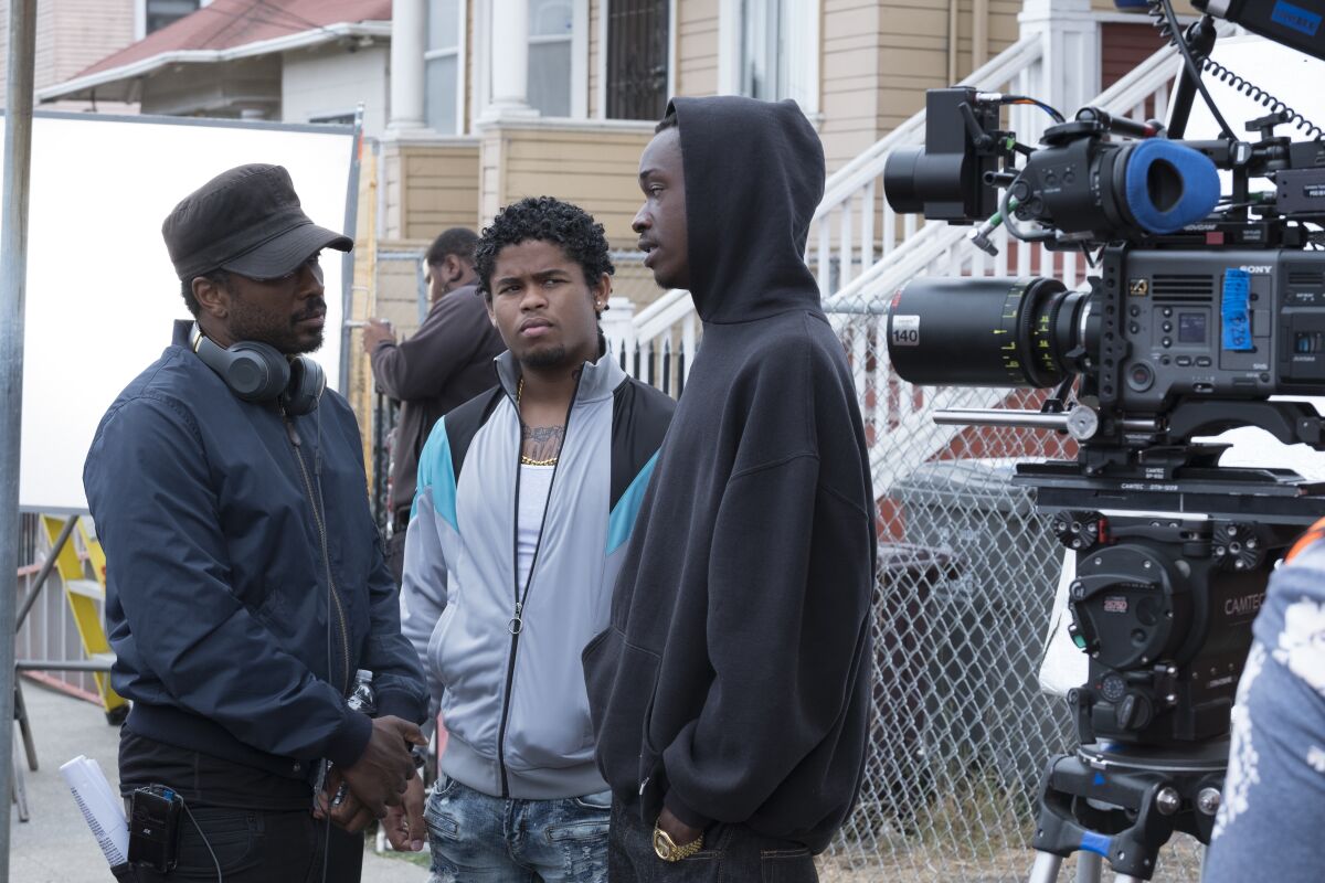 Director Joe Robert Cole, left, with Isaiah John and Ashton Sanders on the set of the Netflix drama "All Day and a Night."
