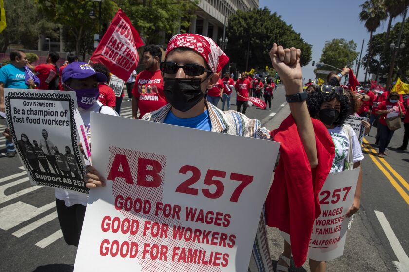 Los Angeles, CA - June 09: Fast-food workers lead a march to the state building on Spring Street after rally at Los Angeles City Hall to protest unsafe working conditions, and to demand a voice on the job through AB 257 Thursday June 8 2022 in Los Angeles. (Brian van der Brug/Los Angeles Times)