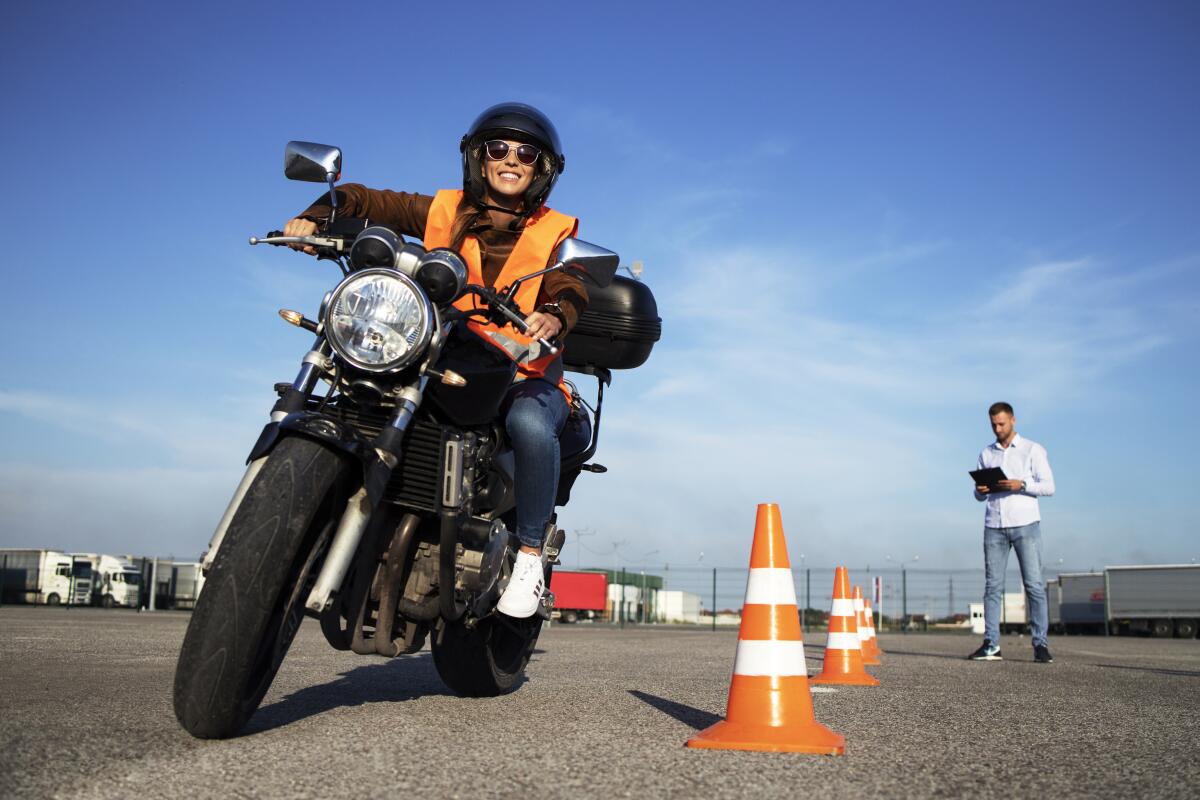 A female student takes motorcycle lessons.
