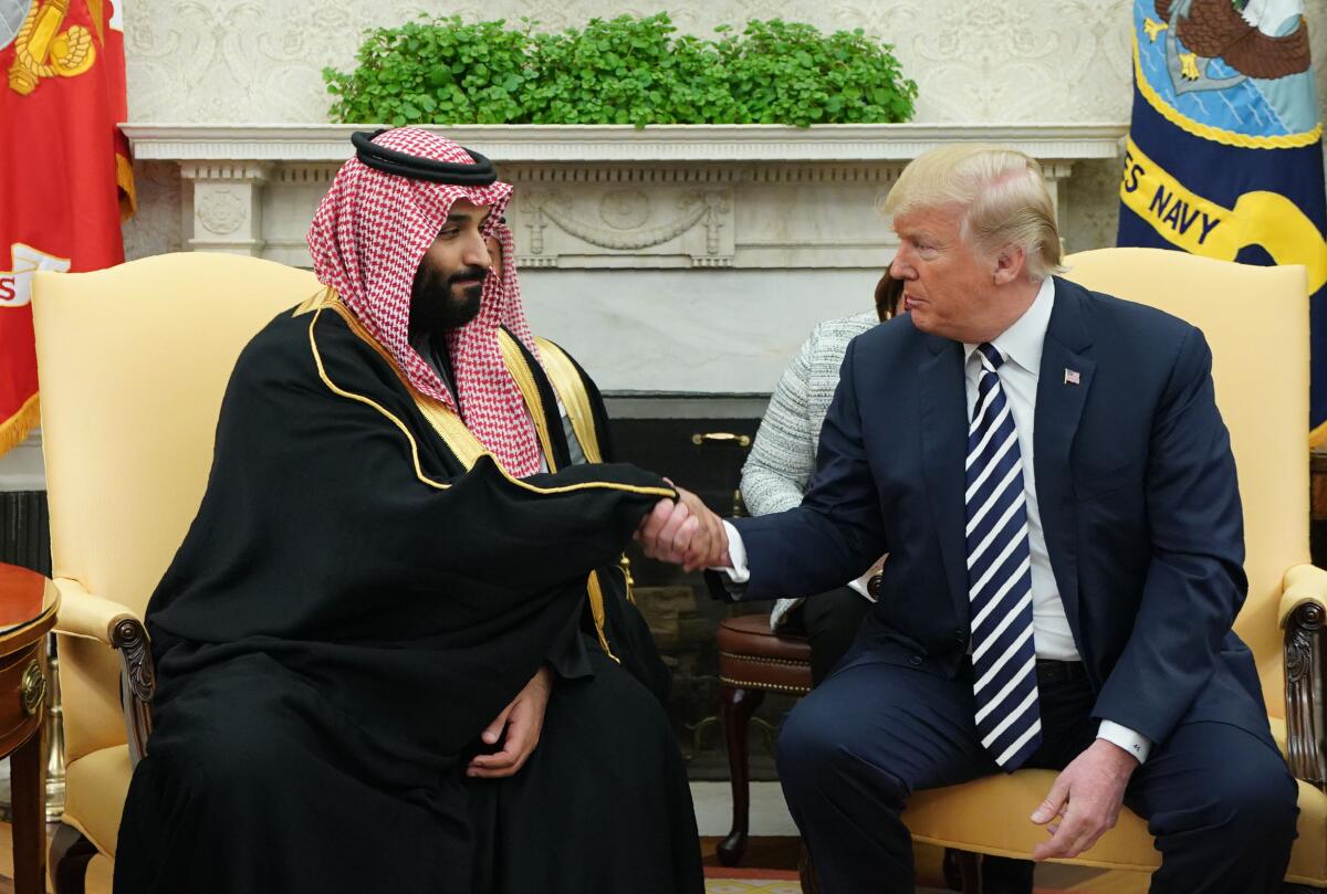 Then-President Trump and Saudi Crown Prince Mohammed bin Salman shake hands in the Oval Office.