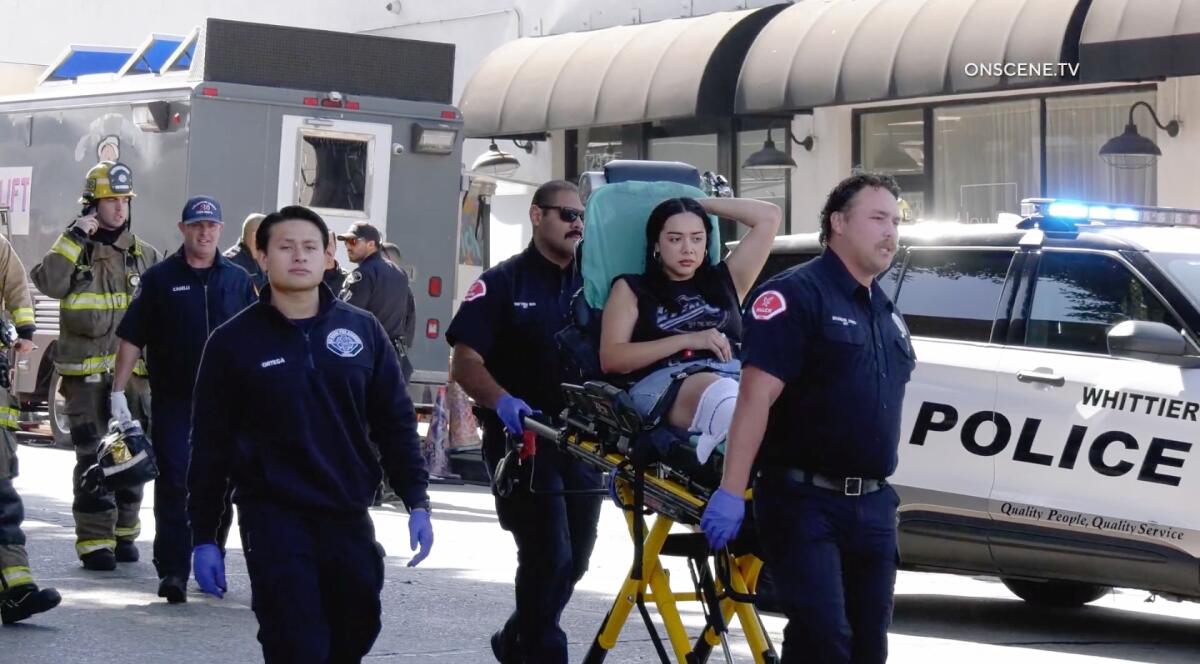 First responders transport a person on a stretcher.