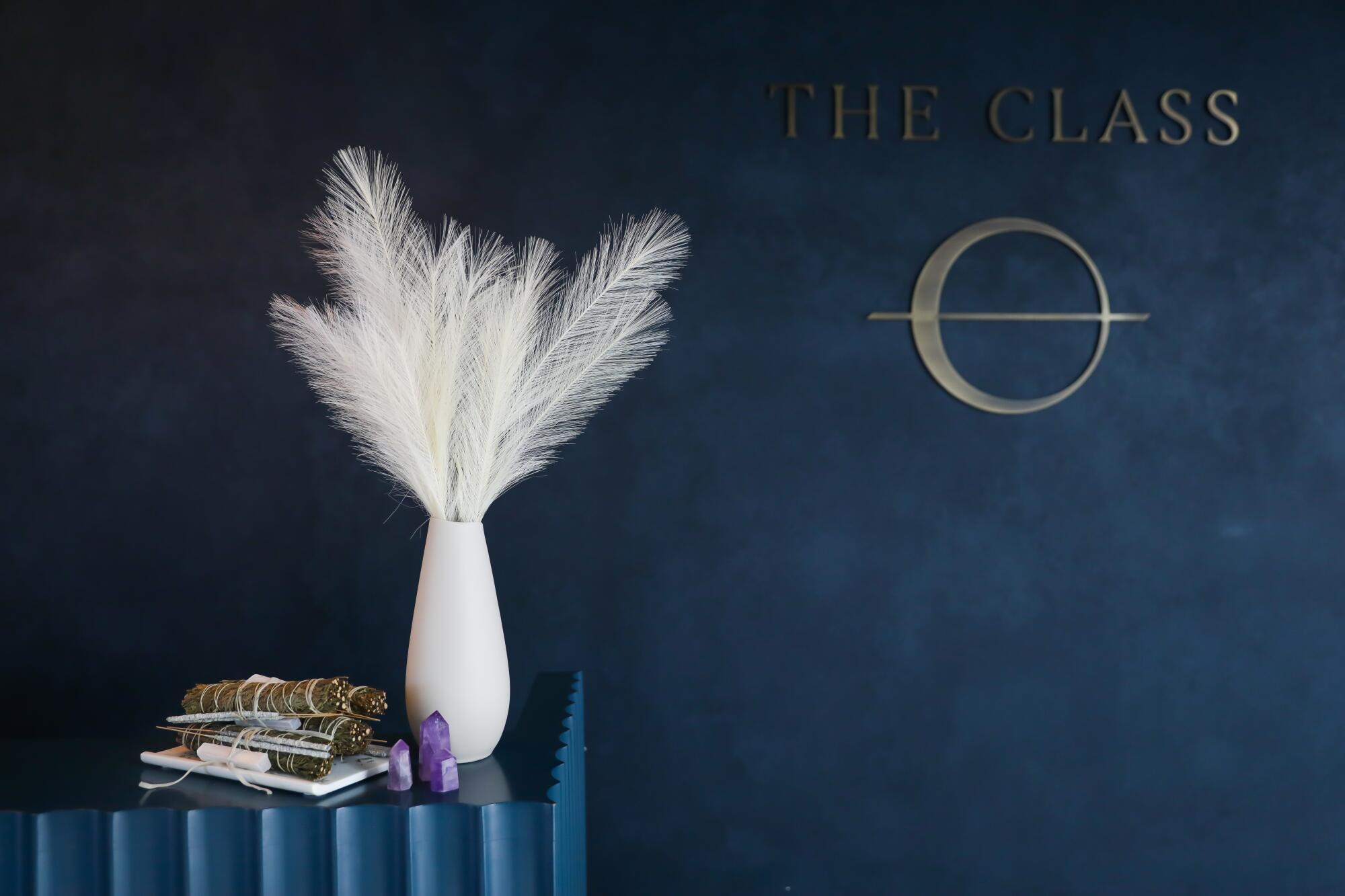 The front desk at the Class in Santa Monica, with a white vase full of white feathers.