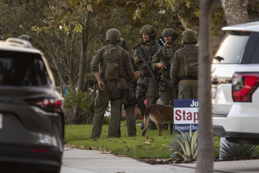 Newport Beach, Ca - October 04: A SWAT team stages near a home where a person is barricaded after several carjackings near Fashion Island on Tuesday, Oct. 4, 2022 in Newport Beach, CA. (Scott Smeltzer / Daily Pilot)