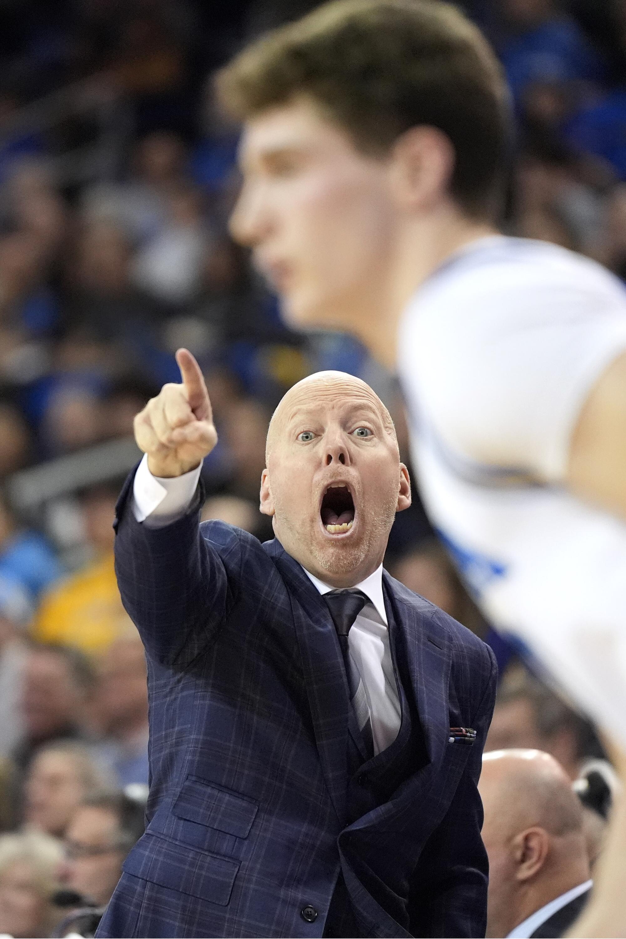 UCLA coach Mick Cronin shouts directions to guard Jan Vide during a win over Washington on Sunday.