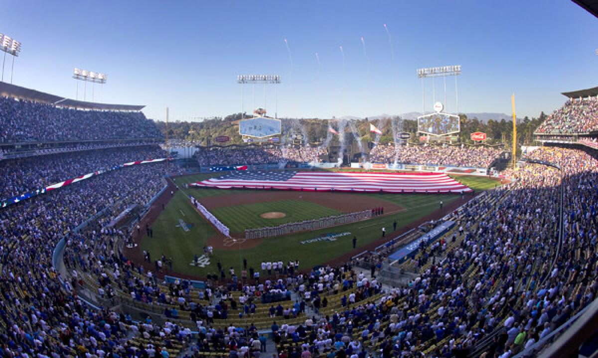 Fireworks and a giant American flag are displayed at Dodger Stadium during the singing of the National Anthem before Game 3 of the National League Championship Series against the St. Louis Cardinals in October. The Dodgers say their new Wi-Fi system will be operational by opening day.