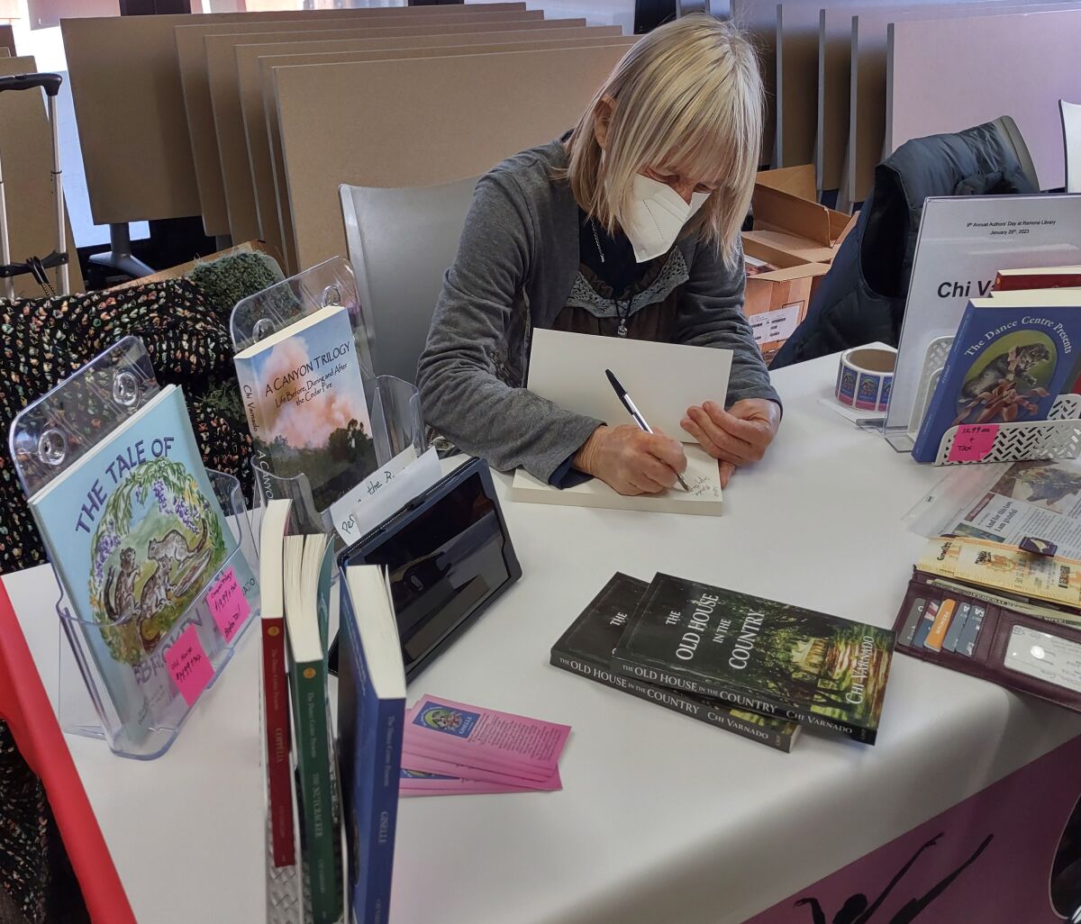 Ramona author Chi Varnado signs a copy of one of her books during Authors’ Day.