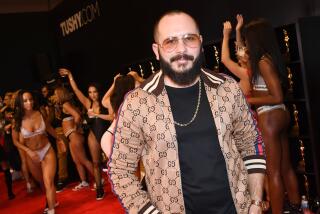Adult film producer/director Greg Lansky poses at his Blacked, Tushy and Vixen adult studios booth.