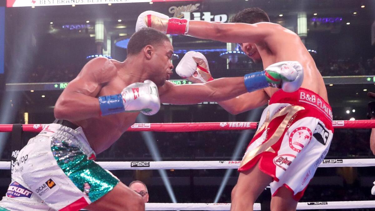 Errol Spence Jr., left, battles Mikey Garcia during their welterweight title fight on Saturday.