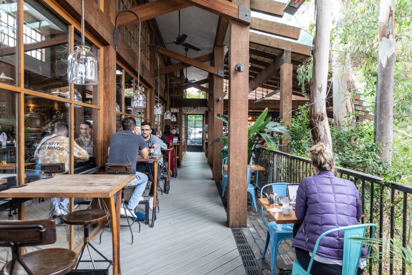 People sit at tables on the patio at Pedalers Fork.