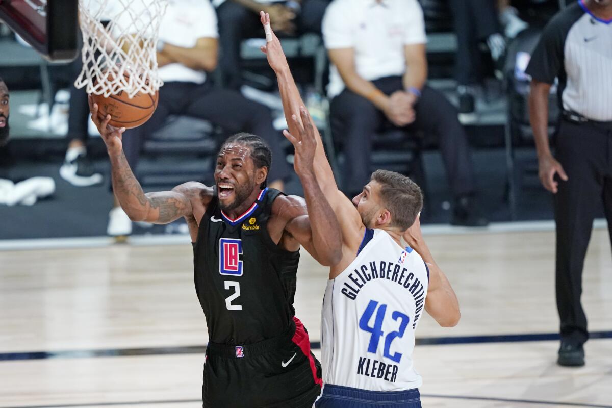 Kawhi Leonard (2) and the Clippers will try to bounce back in Game 3 against Maxi Kleber and the Dallas Mavericks on Friday.