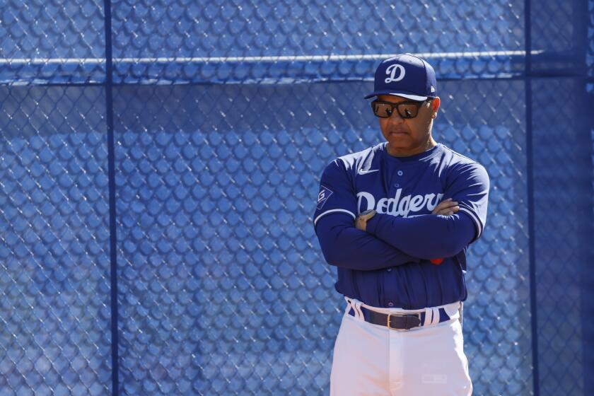 Dodgers manager Dave Roberts looks on during a spring training practice session for pitcher Emmet Sheehan.