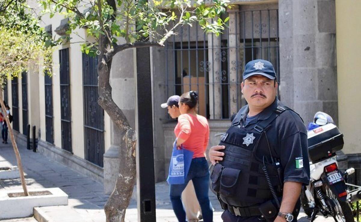 A police officer patrols in downtown Zapopan, outside Guadalajara, Mexico. The mayor's office there recently learned that of the roughly 1,600 police officers who had taken a trustworthiness test, 389 had failed.