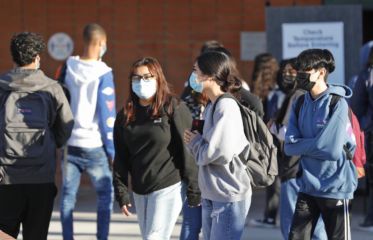 Students return to Costa Mesa High School on the first day back to school in 2020.