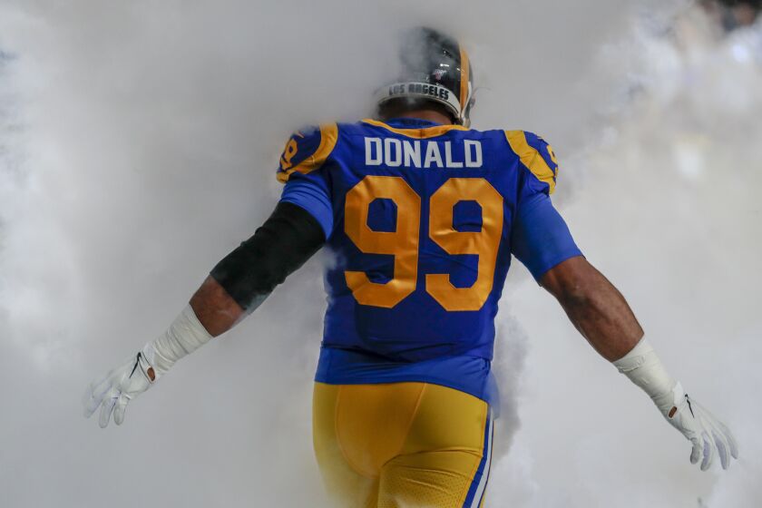 LOS ANGELES, CA, SUNDAY, DECEMBER 8, 2019 - Los Angeles Rams defensive tackle Aaron Donald (99) is shrouded in pregame fog before taking on the Seattle Seahawks at LA Memorial Coliseum. (Robert Gauthier/Los Angeles Times)