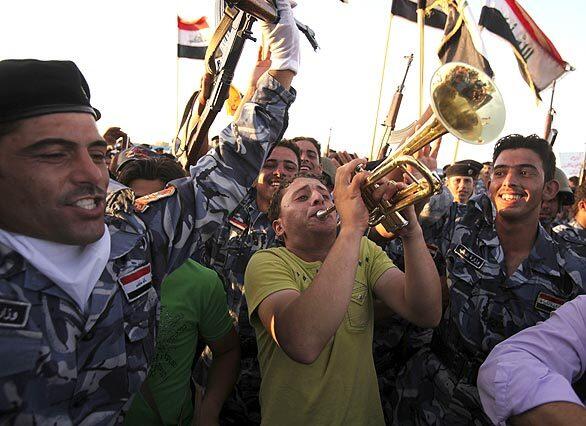Iraqis celebrate in Ramadi, the capital of Anbar province, on Monday, the eve of the formal departure of U.S. troops from Iraqi cities. The pullout is the first step toward winding down the American war effort by the end of 2011.