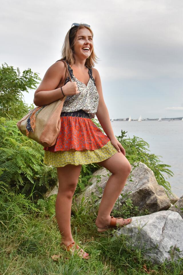 Who: Bridget Rodriguez, 24, Forest Hill resident, 14 West accountant Spotted at: WTMD First Thursday Festival at Canton Waterfront Park What she wore: Ramy Brook multi-color/multi pattern minidress rented from renttherunway.com; green daisy earrings from toryburch.com; tan flat sandals from Old Navy; B. May natural tote she’s had for a while with patchwork scarf – that was a gift – tied onto it; and octagonal sunglasses from Marshalls. She loves to wear lots of patterns: “It’s fun when you mix them, and they work.”