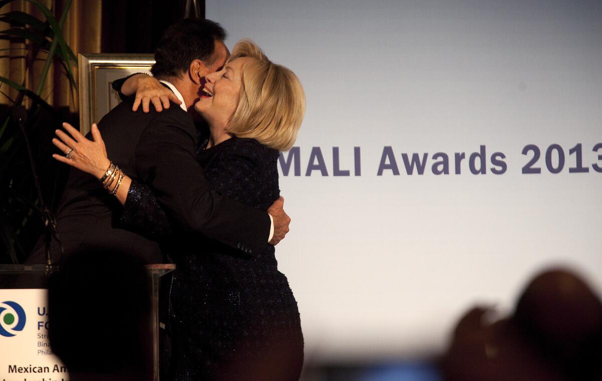 Hillary Rodham Clinton embraces Henry Cisneros, former U.S. secretary of Housing and Urban Development, after he introduced her at a brunch benefiting the Mexican-American Leadership Initiative at USC.