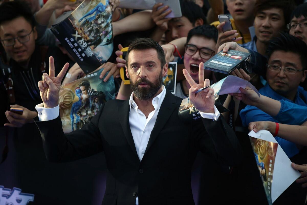 Hugh Jackman poses for a photo with Chinese fans at a news conference last month in Beijing for "X-Men: Days of Future Past."
