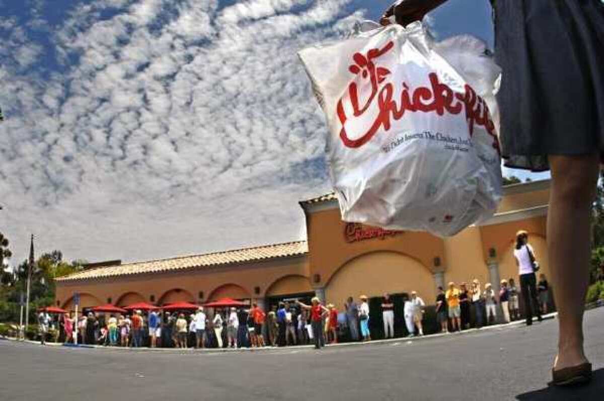 A Tuscon executive is out a job after recording his confrontation with a Chick-fil-A employee. Above, hundreds of customers line up at a Chick-fil-A restaurant in Laguna Niguel.