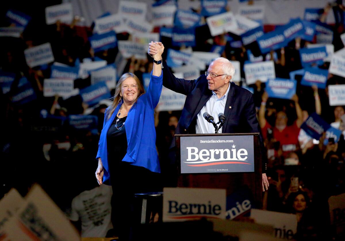 Sen. Bernie Sanders and his wife, Jane, arrive on stage during a rally on Sunday at the Los Angeles Convention Center. The Los Angeles Fire Department estimated the crowd to be more than 15,000 people.