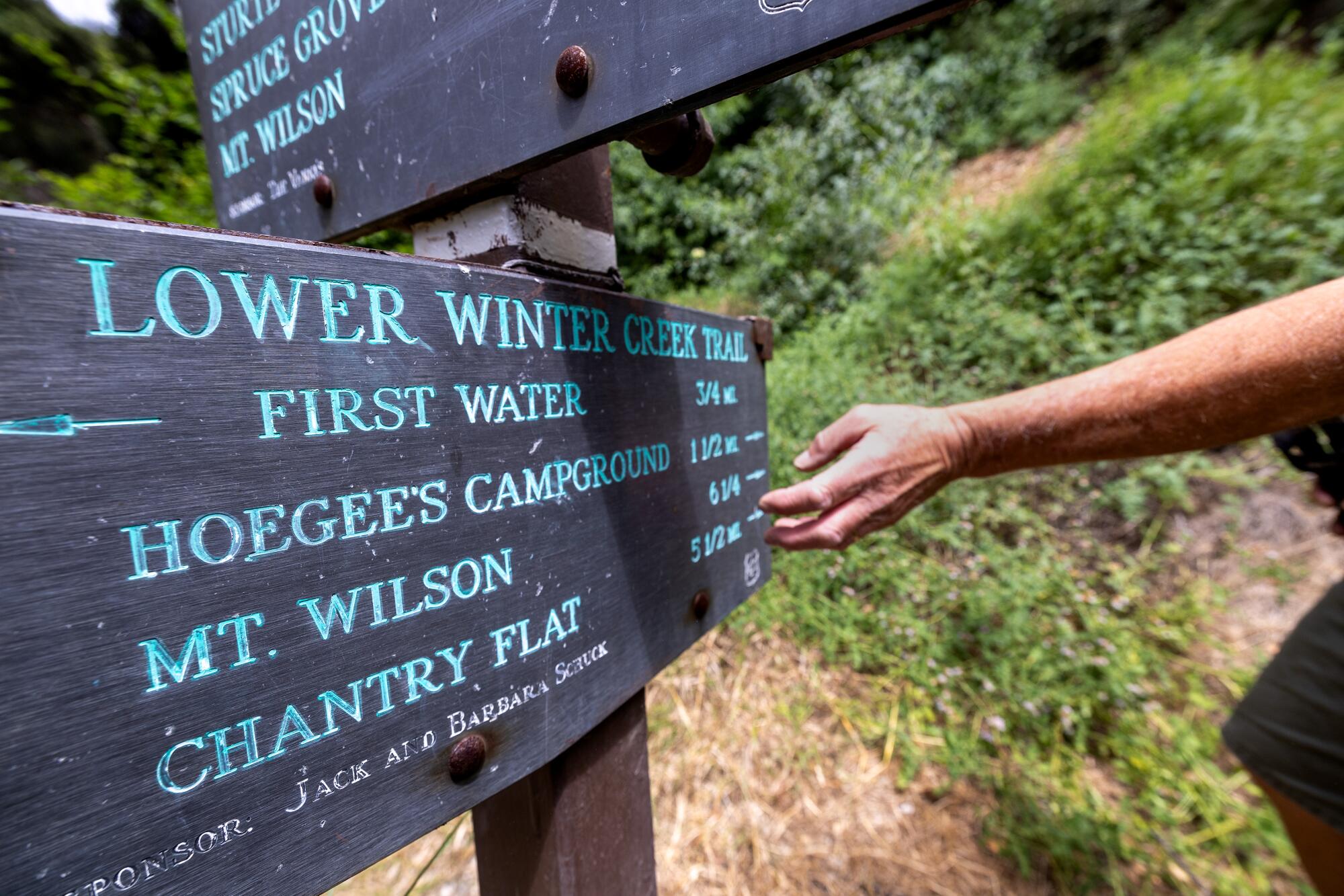 A trail sign shows distances to Hoegee's Campground, Mt. Wilson and Chantry Flat.