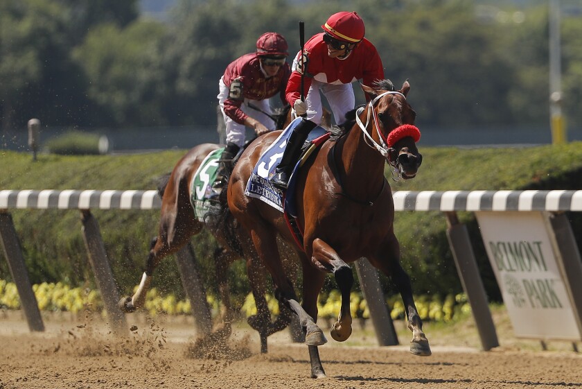 Jose Ortiz, right, reacts as he crosses the finish line with Letruska (3) to win the 53rd running of the Ogden Phipps horse race, Saturday, June 5, 2021, at Belmont Park in Elmont, N.Y. (AP Photo/Julie Jacobson)