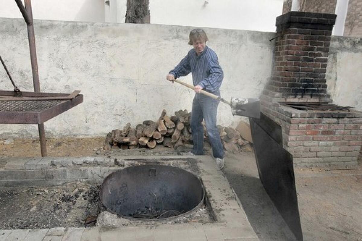 PAY DIRT: Jordan Vannini, president of L.A.s Slow Food chapter, lends a hand in re-creating an old-style pit barbecue feast.