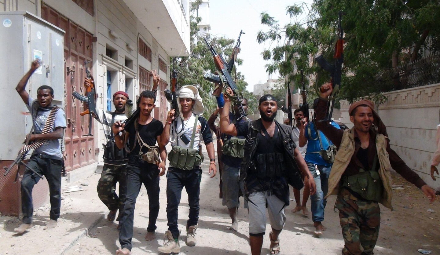 Fighters opposing Houthi rebels shout slogans as they walk in the southern Yemeni city of Aden on April 8 as clashes continue to rage in the embattled city between Shiite Houthi rebels and forces loyal to fugitive Yemeni President Abedrabbo Mansour Hadi.
