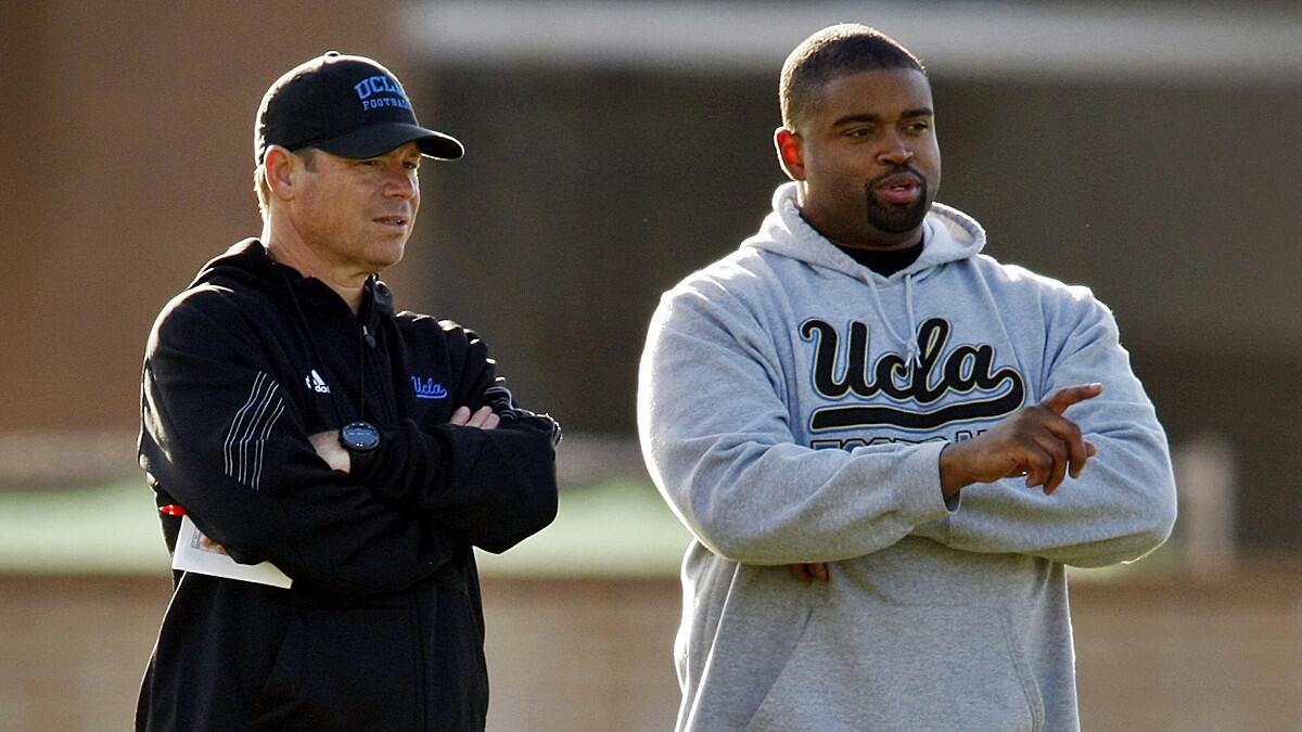 UCLA Coach Jim Mora, left, and offensive line coach Adrian Klemm look on during a team practice session in April. Klemm was not happy with how the offensive line performed against Virginia on Saturday.