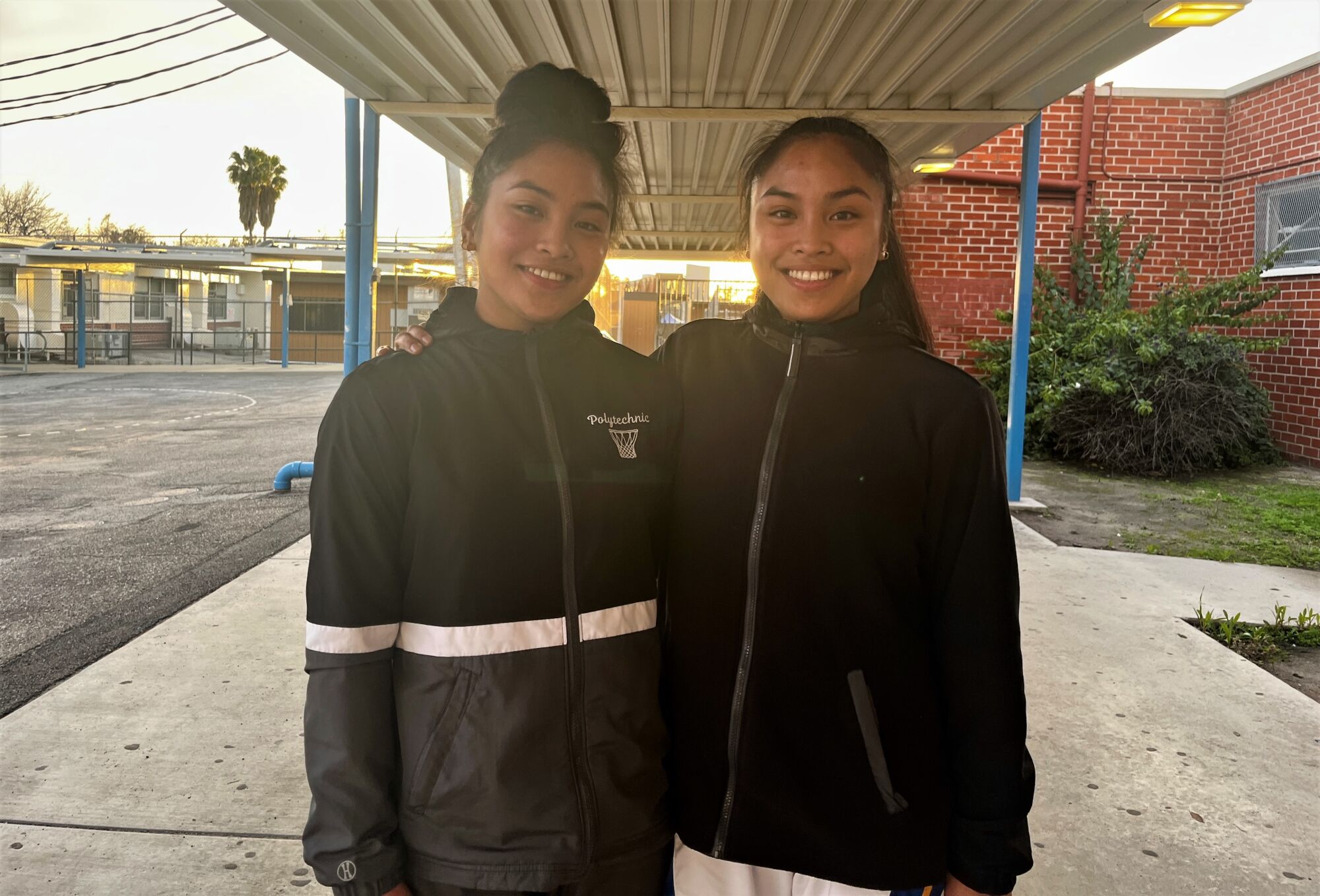 Twins Heart and Hannah Lising pose for a photo at Sun Valley Poly High.