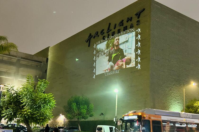 The art collective Indecline projected images of the war in Gaza on the side of several Hollywood buildings Monday evening.