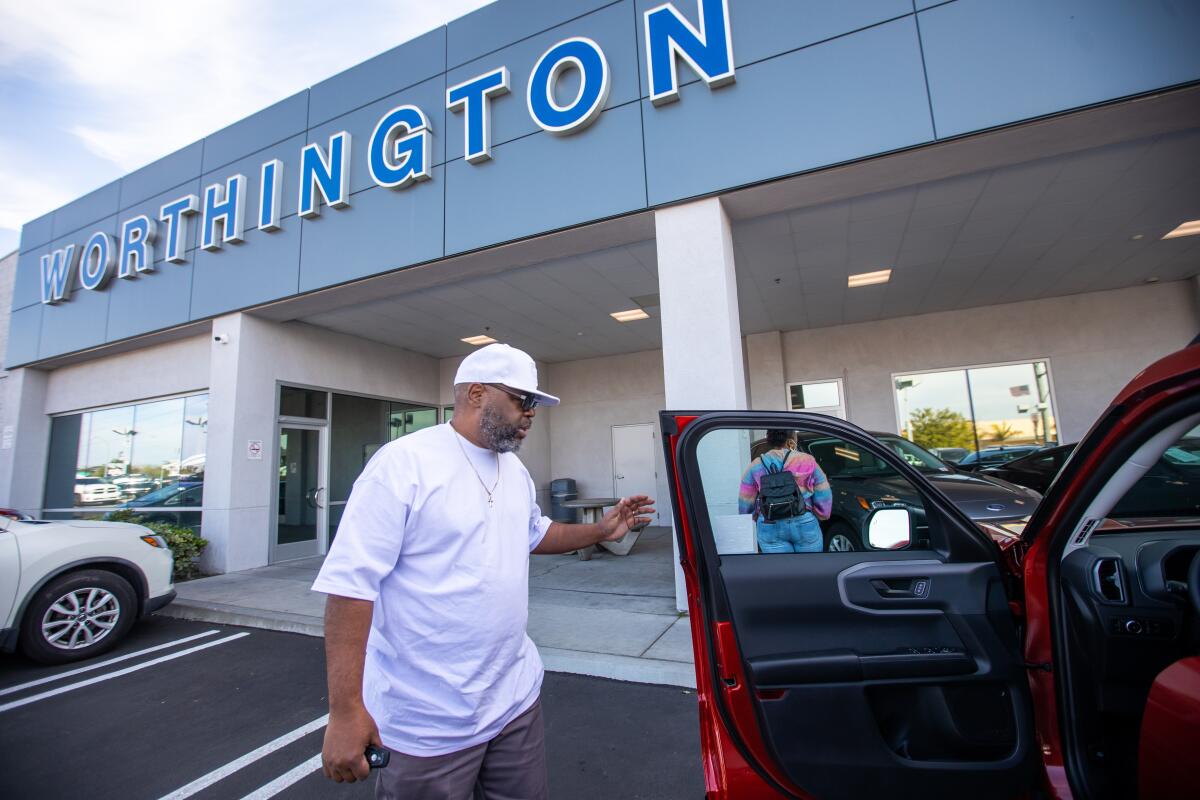 Anthony Crawford reviews new vehicles at Worthington Ford on Saturday.