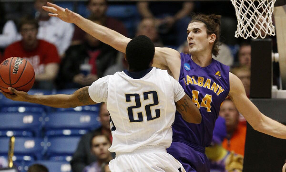 Mount St. Mary's Rashad Whack, left, puts up a shot in front of Albany's John Puk during the first half of Albany's 71-64 win on Tuesday.