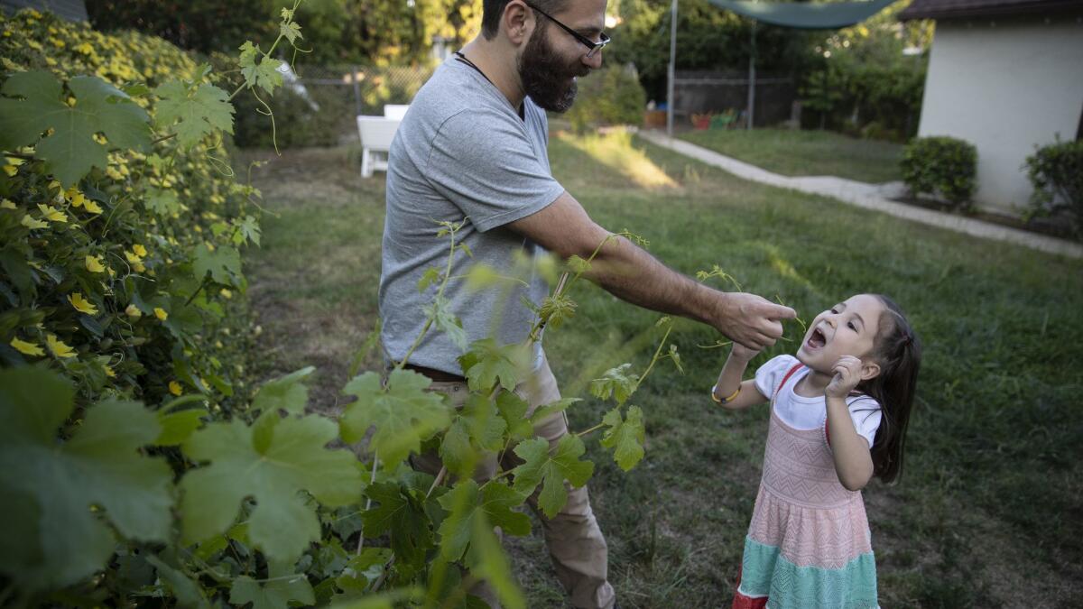 Los Angeles Times reporter Esmeralda Bermudez and her husband David, left, committed to speaking only Spanish and Armenian to their daughter from the day she was born. The 5-year-old girl picked up English on her own and she's also learning French.