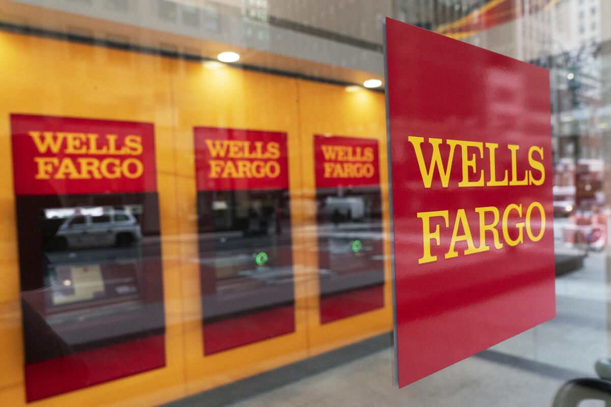 FILE - This Jan. 13, 2021 file photo shows a Wells Fargo office in New York. Wells Fargo easily beat Wall Street's third-quarter revenue forecasts, Friday, Oct. 14, 2022, as higher interest rates helped offset a steep decline in home lending. (AP Photo/Mark Lennihan, File)