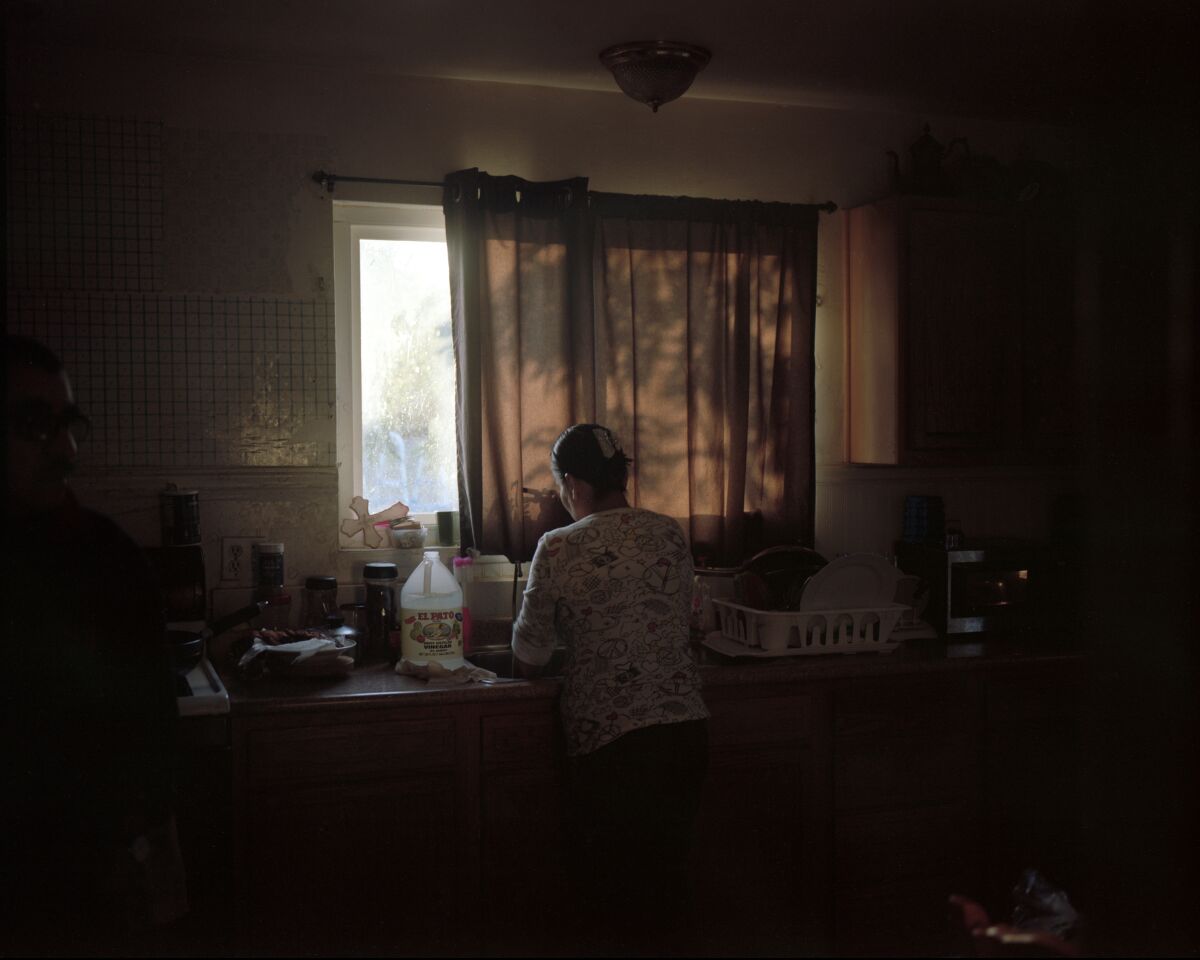 William Camargo documents his home life in "My Mother At The Sink," 2020.