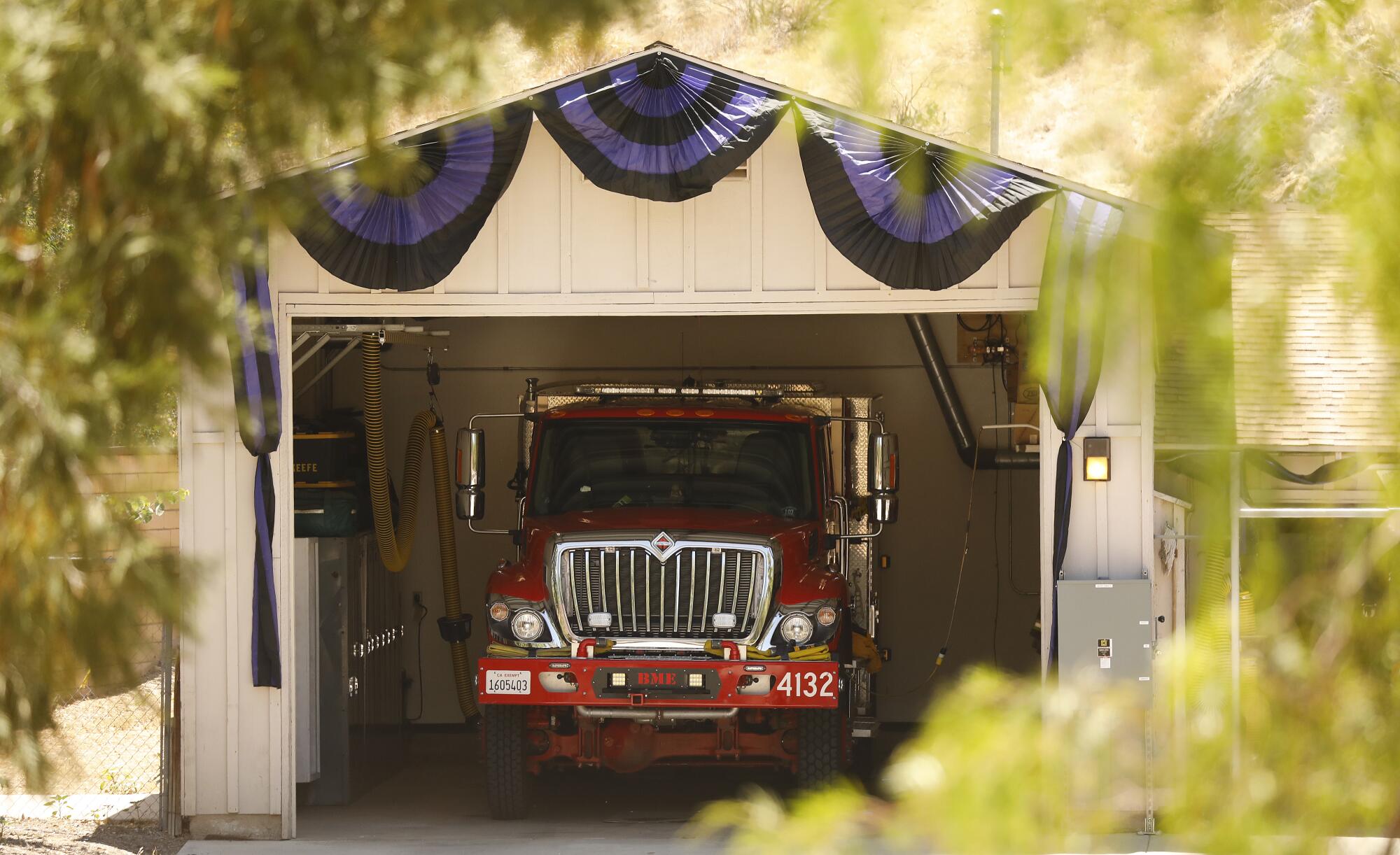 Mourning drapes hang above a fire engine at L.A. County Fire Station 81 in Agua Dulce.
