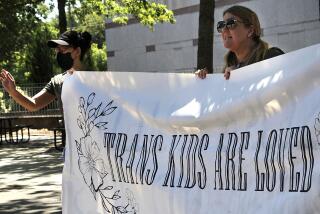 Heather Redding, left, and Elizabeth Waugh, of Orange County, North Carolina, rally for transgender rights outside the state Legislative Building in Raleigh, N.C., Wednesday, Aug. 16, 2023. North Carolina Republicans will attempt Wednesday to override the Democratic governor's veto of legislation banning gender-affirming health care for minors. (AP Photo/Hannah Schoenbaum)