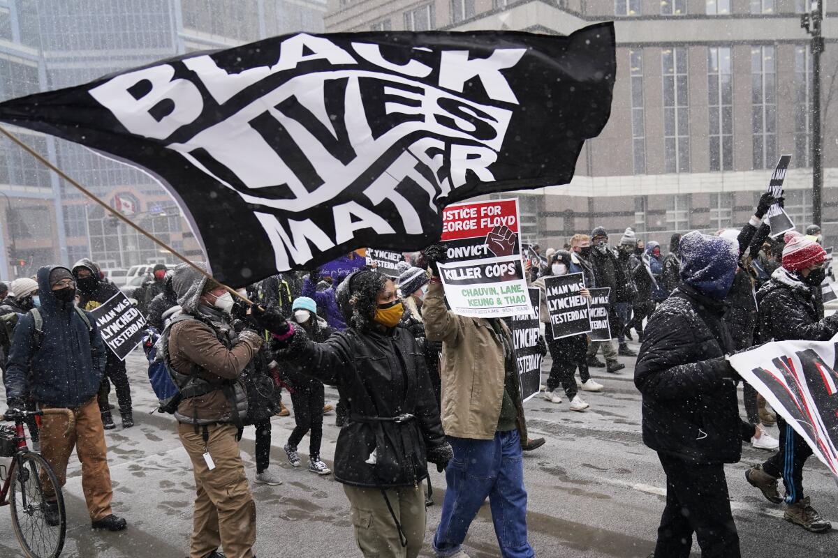 Protesters march outside Hennepin County Government Center on Monday in Minneapolis