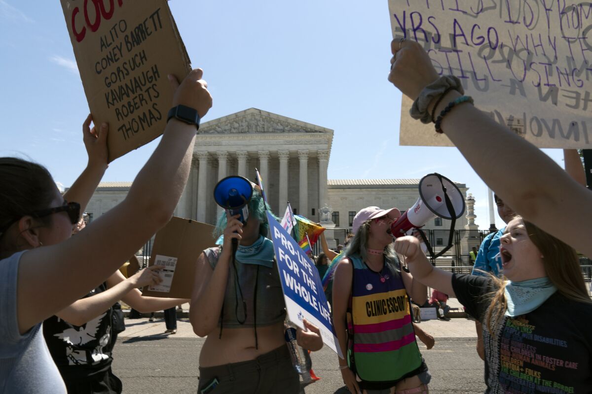 Anti-abortion demonstrators and abortion right activists protest outside the Supreme Court on June 25.