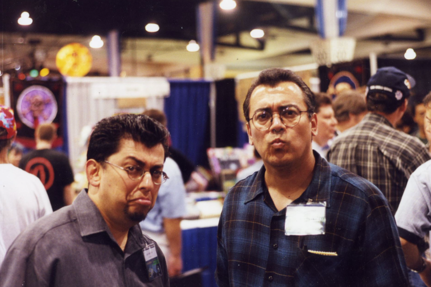 Two brothers making faces at the camera during a convention