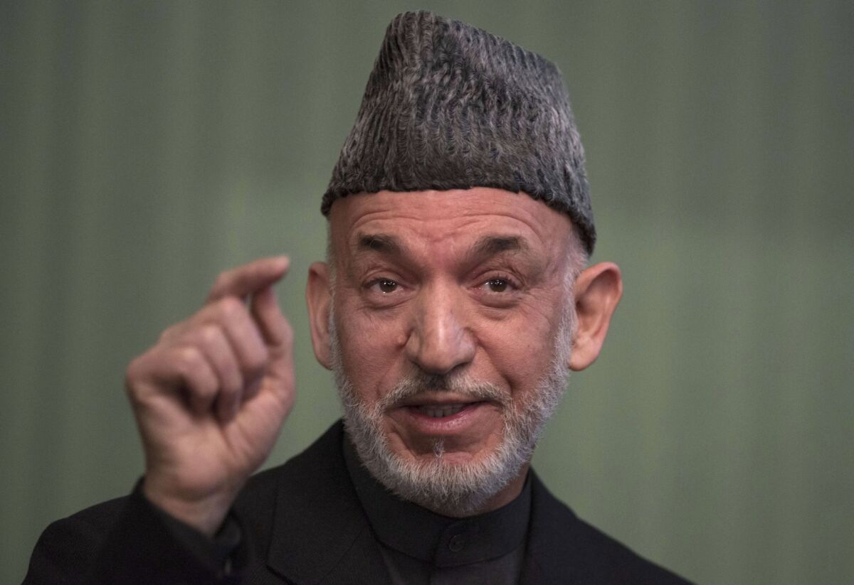 Former President Hamid Karzai, pictured in 2014, is now viewed by many Afghans as a sociable and engaging father figure.