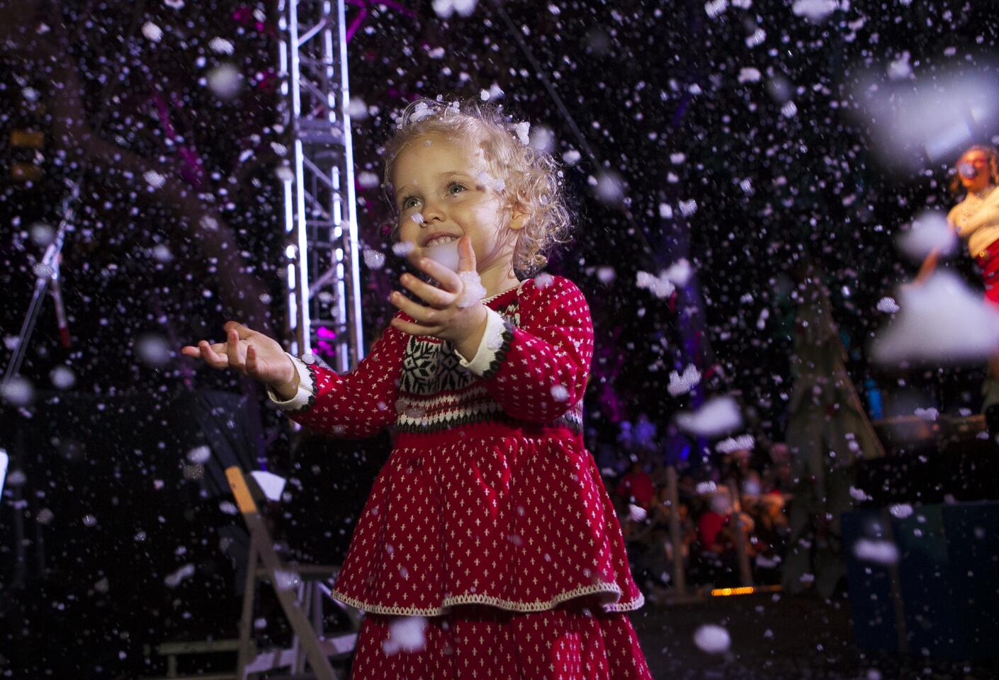 Avery Aguirre, 2, admires the snow at the event.