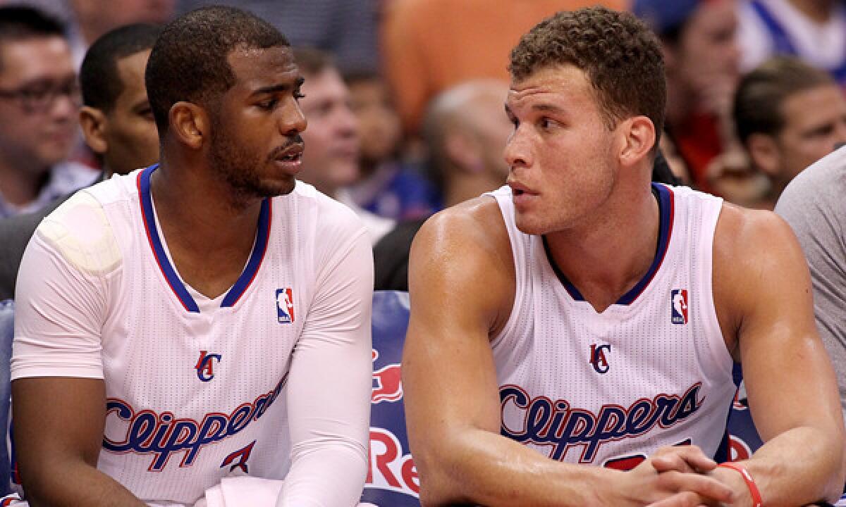 Clippers teammates Chris Paul, left, and Blake Griffin talk on the bench during a win over the Phoenix Suns on March 10. Playing three games in four days has taken a physical toll on the Clippers.