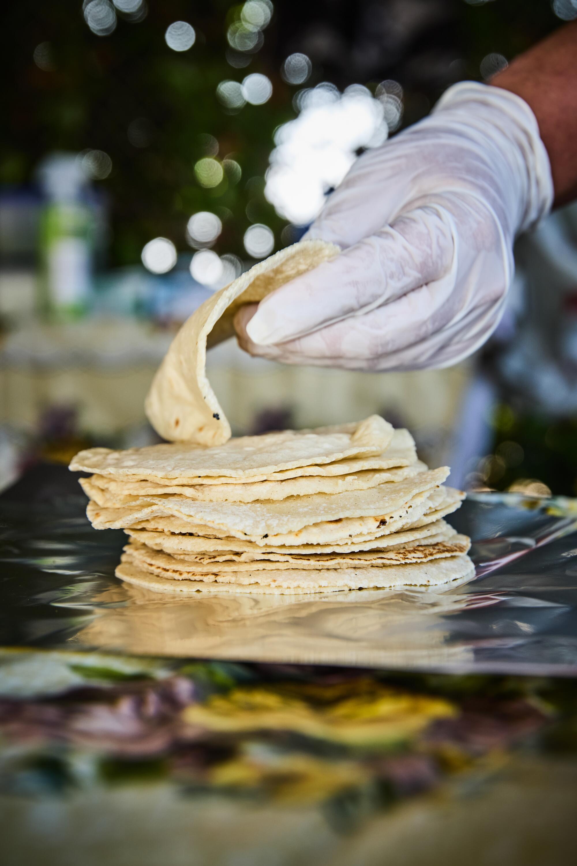Soft tortillas being stacked.