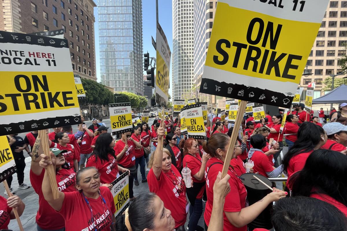 Hotels workers walk a picket line on Sunday in Los Angeles.