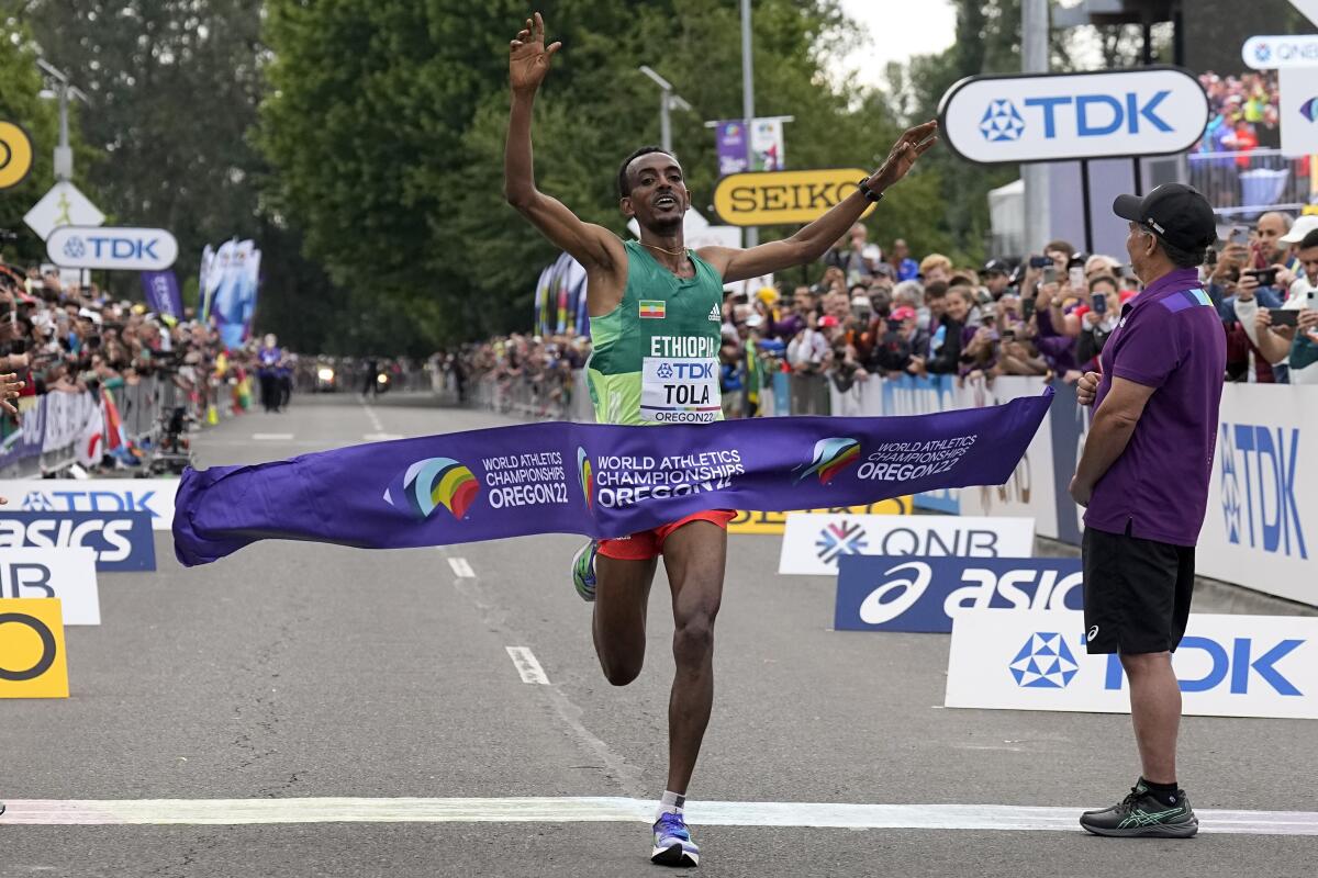 Tamirat Tola, of Ethiopia, celebrates after winning the men's marathon at the World Athletics Championships on Sunday, July 17, 2022, in Eugene, Ore. (AP Photo/Gregory Bull)